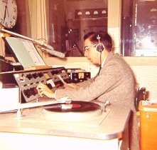 Bill Newbrough at the console, showing the old Collins board and turntables